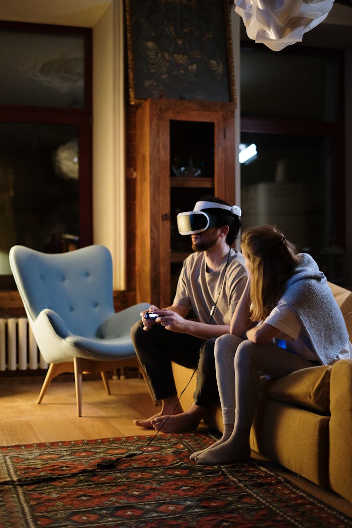 Couple enjoying virtual reality gaming in a cozy living room ambiance during the evening.